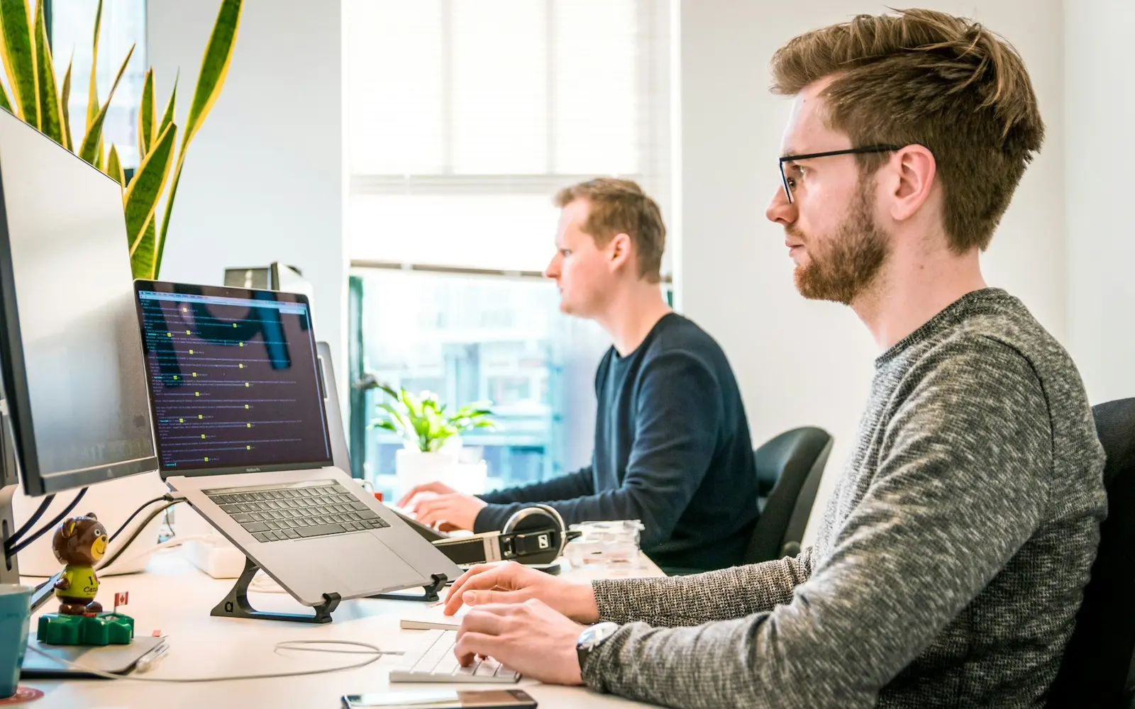 Business team planning automation workflows on laptops