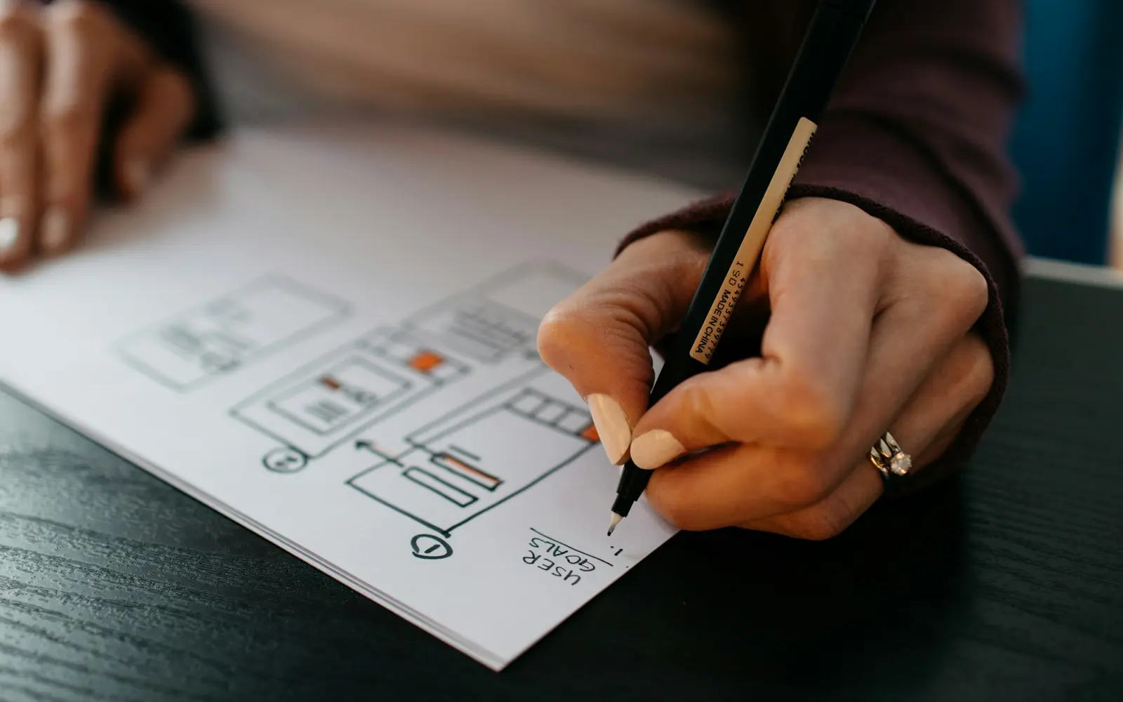 Designer sketching UX wireframes before development
